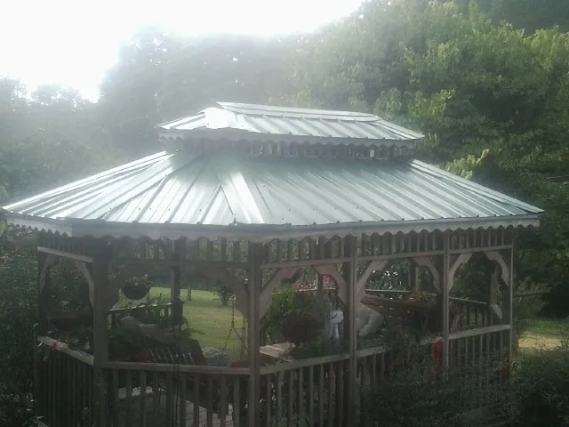 Two tier green metal roof on a garden gazebo in Lamoni